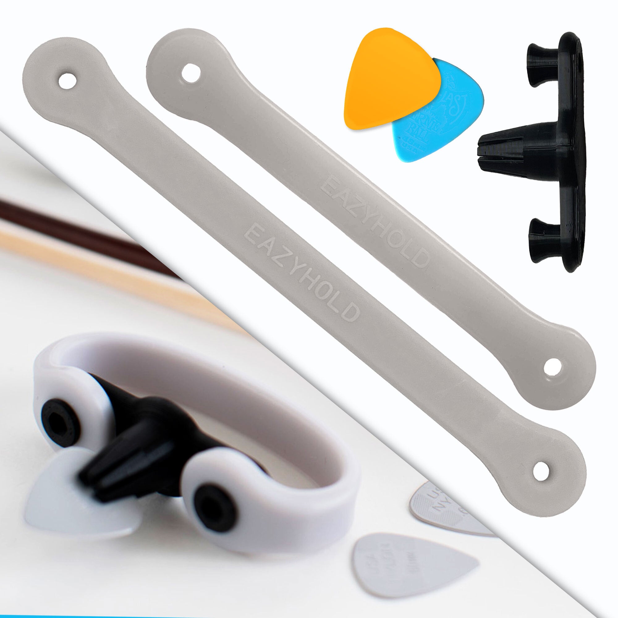 A black pick-holder device with a light grey strap. Next to that on a white background, one small and one medium silicone EasyHold strap, two picks, and a Strumling pick holder.