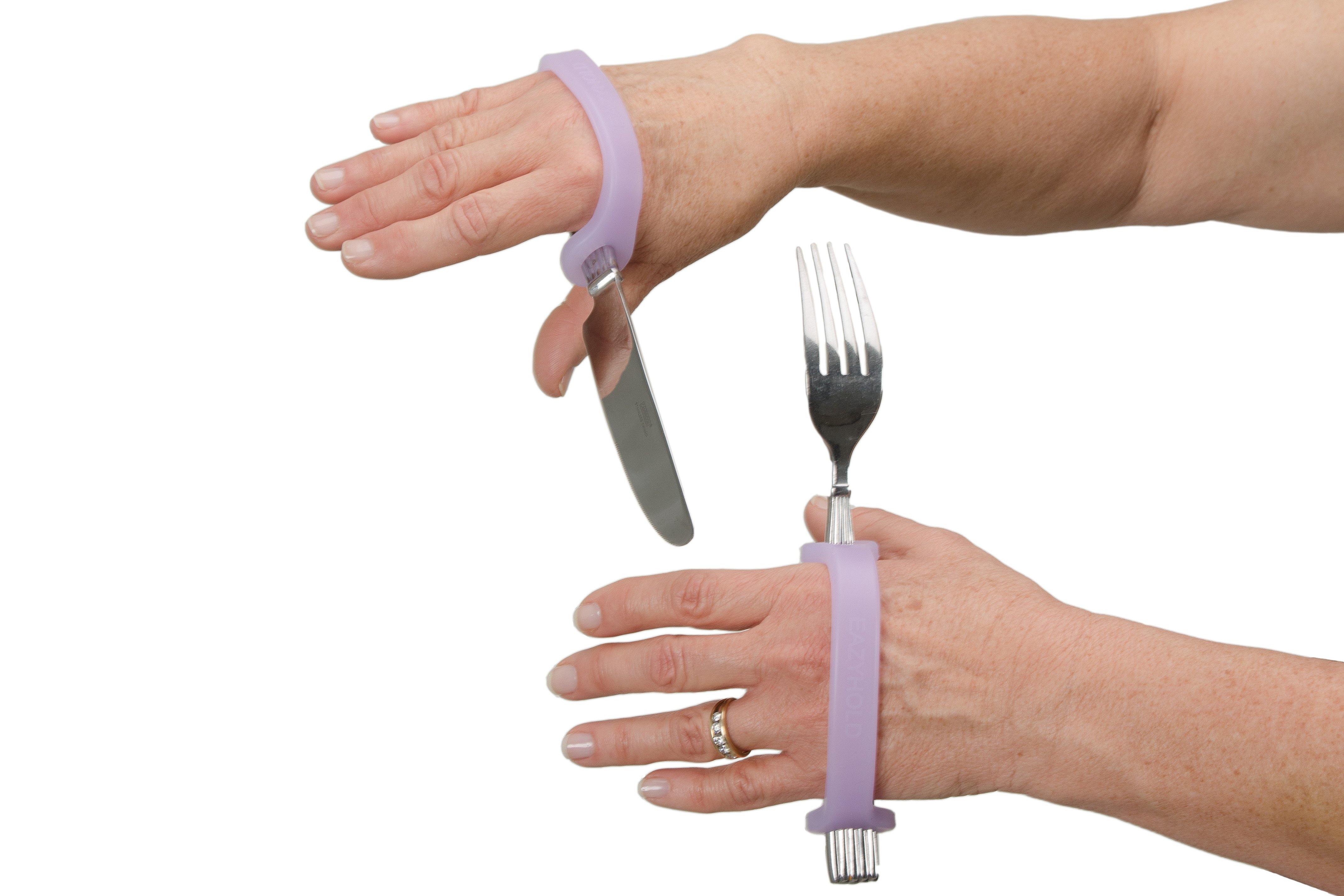 alt="Womans hands holding a knife and fork with the aid of EazyHold lavender eating silicone cuff"
