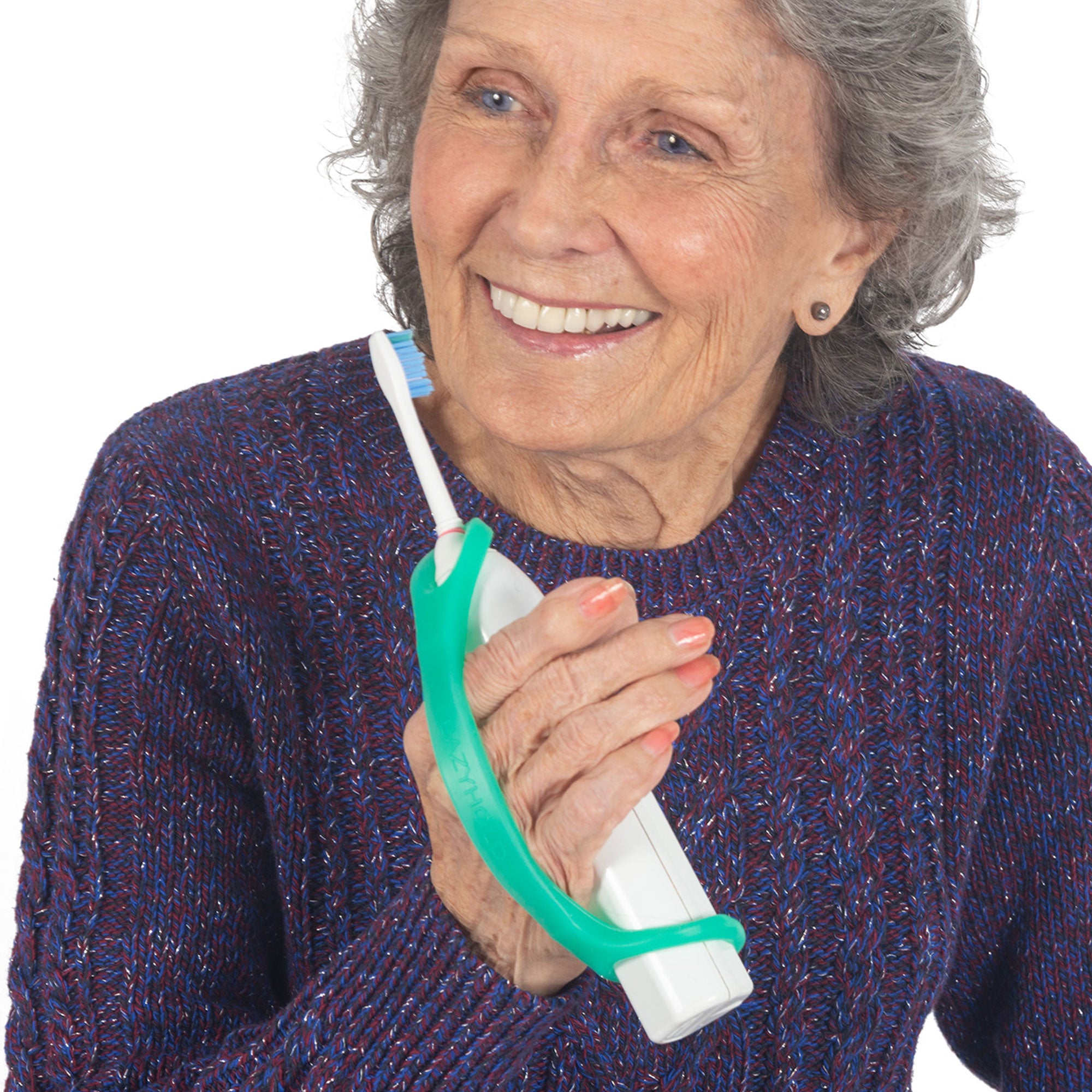 Elderly woman holding an electric toothbrush with an aqua silicone EasyHold universal cuff.