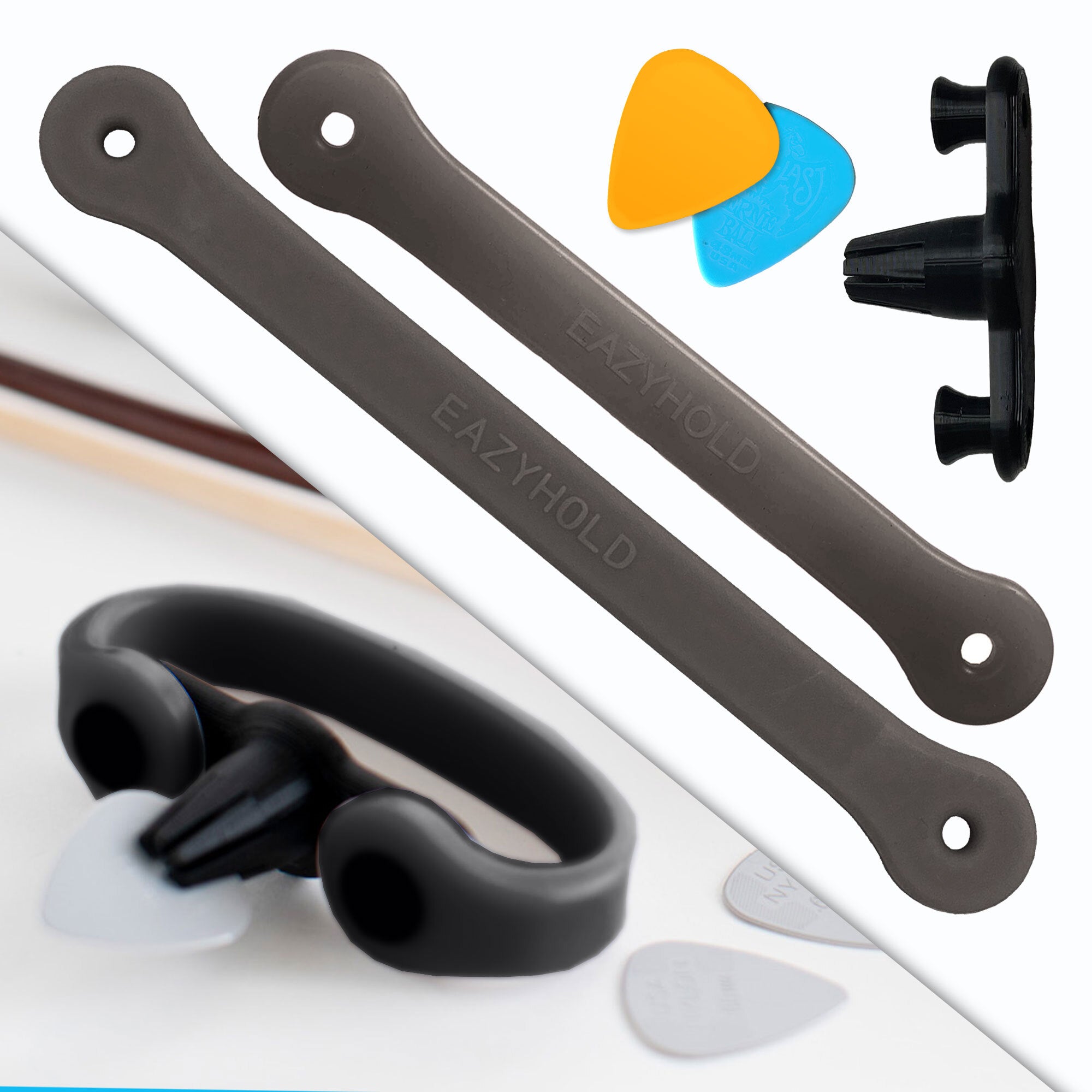A black pick-holder device with a black strap. Next to that on a white background, one small and one medium silicone EasyHold strap, two picks, and the Strumling pick holder.