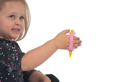 Little girl with grip issues hold a crayon adapted with a pink eazyhold silicone cuff