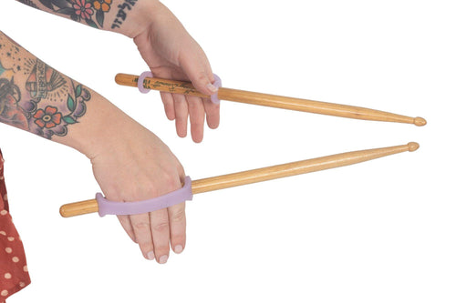 Disabled adult grasps drumsticks with modified an eazy to hold U cuff