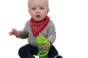 Infant with a disability holds his own bottle with the help of a large green eazyhold grip assist