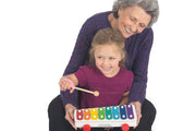 Mom with special needs child playing an instrument with and adaptive aid