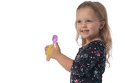 Happy girl holds her own spoon with a tiny yellow grip aid for children.